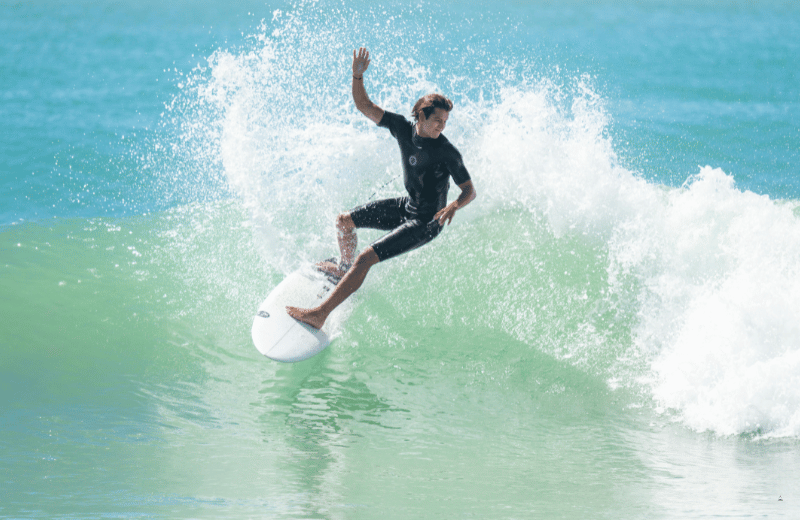 Surfer at sunrise on the point break at Arugam Bay, Sri Lanka